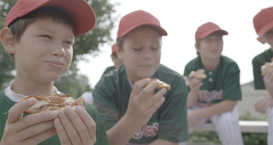 Youth baseball team enjoying LaRosa's pizza